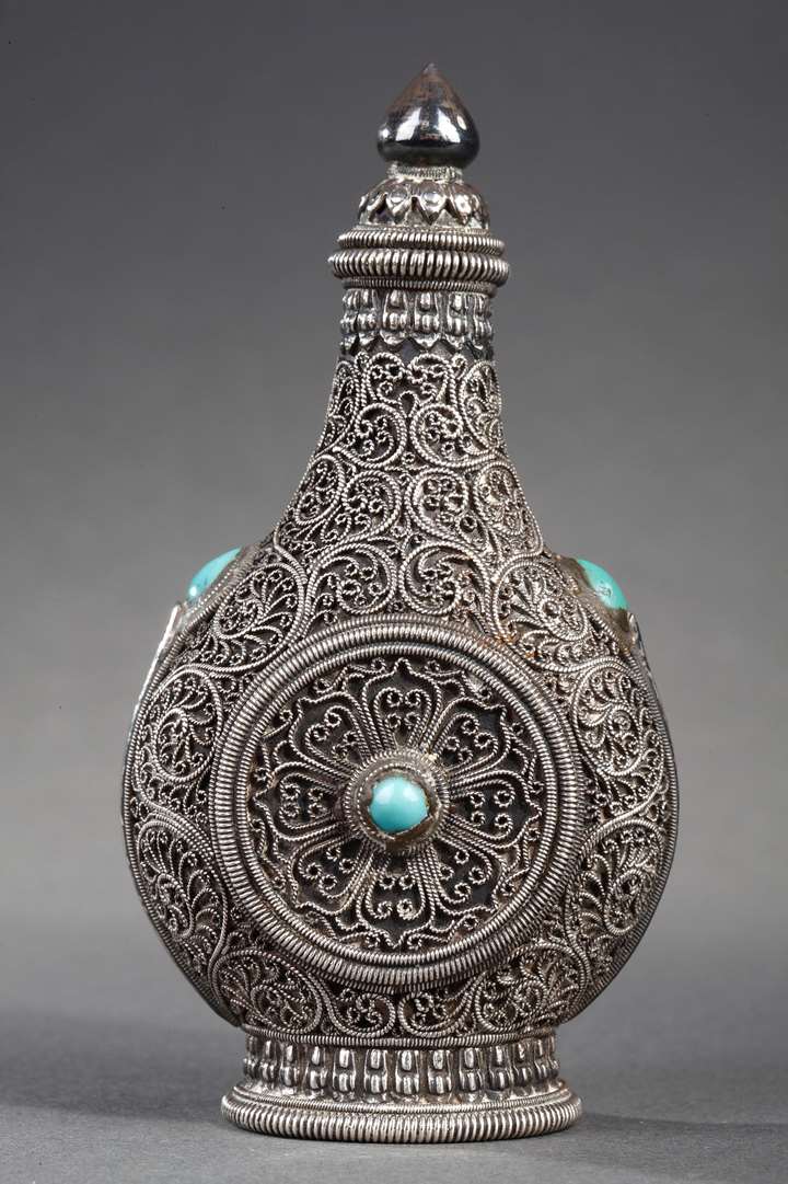 Nice snuff bottle Mongolian silver decorated on the filigree ground  and embellished with turquoise on each face.